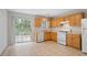 Functional kitchen with updated appliances, ample counter space, and a sliding glass door leading to the backyard area at 3116 Fields Dr, Lithonia, GA 30038