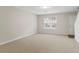 Minimalist living room features neutral walls, carpeted flooring, and a large window that provides ample natural light at 3116 Fields Dr, Lithonia, GA 30038