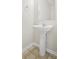 This powder room features a pedestal sink with modern faucet and neutral decor at 3116 Fields Dr, Lithonia, GA 30038