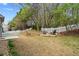 A sprawling backyard featuring a fire pit area, terraced garden beds, and a well-maintained lawn at 3806 Carriage House Dr, Cumming, GA 30040