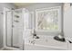 Spa-like bathroom featuring a shower and jacuzzi tub next to a large window at 3806 Carriage House Dr, Cumming, GA 30040