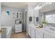 Bright bathroom with double vanity, white cabinets, and a separate soaking tub at 3806 Carriage House Dr, Cumming, GA 30040