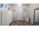 Bedroom featuring neutral walls, wood-look flooring, white trim, and ample closet space at 3806 Carriage House Dr, Cumming, GA 30040