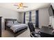 Comfortable bedroom with a ceiling fan, neutral walls, and a workstation near the window at 3806 Carriage House Dr, Cumming, GA 30040