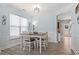 Bright dining area features wood floors, a modern light fixture and a large window allowing for natural light at 3806 Carriage House Dr, Cumming, GA 30040