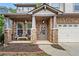 Inviting front porch with stone pillars and a cozy seating area, perfect for relaxing outdoors at 3806 Carriage House Dr, Cumming, GA 30040