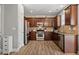 Well-equipped kitchen with stainless steel appliances, wooden cabinets and ample counter space at 3806 Carriage House Dr, Cumming, GA 30040