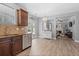 Open-concept kitchen with stainless steel appliances, elegant lighting, and seamless flow to the living area at 3806 Carriage House Dr, Cumming, GA 30040