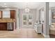 Spacious dining area adjacent to the kitchen, featuring stylish lighting and French doors to the backyard at 3806 Carriage House Dr, Cumming, GA 30040