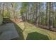 Spacious backyard with a fenced perimeter and stone patio, perfect for entertaining at 925 Crab Orchard Dr, Roswell, GA 30076