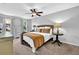 Cozy bedroom features neutral decor, ceiling fan, and comfortable furnishings creating a relaxing space at 925 Crab Orchard Dr, Roswell, GA 30076