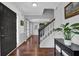 Elegant home foyer featuring hardwood floors, staircase, stylish console table, and tasteful decor at 925 Crab Orchard Dr, Roswell, GA 30076