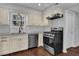 Modern kitchen featuring stainless steel appliances, sleek countertops, and ample cabinet space at 925 Crab Orchard Dr, Roswell, GA 30076