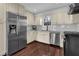 Well-lit kitchen with stainless steel appliances, granite countertops, and hardwood floors at 925 Crab Orchard Dr, Roswell, GA 30076