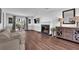 Open-concept living area with fireplace, hardwood floors, and access to outdoor patio at 925 Crab Orchard Dr, Roswell, GA 30076