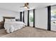 Bright main bedroom with ceiling fan and large windows at 925 Crab Orchard Dr, Roswell, GA 30076