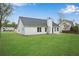View of the home's rear exterior, showcasing a well-maintained lawn and back patio area at 111 Shenandoah Ct, Hiram, GA 30141