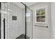 Modern bathroom showcases a tiled shower with glass door and window at 111 Shenandoah Ct, Hiram, GA 30141