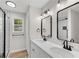 Bathroom featuring double sink vanity, mirrors, and a modern tiled shower at 111 Shenandoah Ct, Hiram, GA 30141