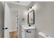 The bathroom includes sleek lighting, neutral paint, updated vanity and a doorway to another room at 111 Shenandoah Ct, Hiram, GA 30141