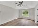 Bright bedroom offers a tray ceiling, ceiling fan, and a scenic window view at 111 Shenandoah Ct, Hiram, GA 30141