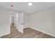 This bedroom features a sleek ceiling light, wood-look flooring, neutral paint and an open doorway at 111 Shenandoah Ct, Hiram, GA 30141