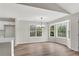 Open dining area featuring a bay window, modern chandelier, and wood look flooring at 111 Shenandoah Ct, Hiram, GA 30141