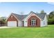 Charming brick and white home with a well-manicured lawn and a spacious two-car garage at 111 Shenandoah Ct, Hiram, GA 30141