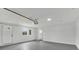 Spacious garage with freshly painted white walls and gray flooring, providing ample room for parking and storage at 111 Shenandoah Ct, Hiram, GA 30141