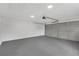 Clean, spacious garage with a smooth concrete floor and an overhead door, perfect for parking or storage at 111 Shenandoah Ct, Hiram, GA 30141