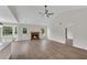 Bright open-plan living area with vaulted ceiling, fireplace and wood look flooring at 111 Shenandoah Ct, Hiram, GA 30141