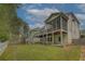 Backyard view showcasing a spacious deck, screened porch, lush lawn, and mature trees at 1658 Lightfoot Cir, Marietta, GA 30062