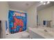 This bathroom features a Spiderman shower curtain, tile flooring and vanity with sink at 1658 Lightfoot Cir, Marietta, GA 30062