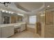 The bathroom has double sinks, large mirror, gold shower and soaking tub at 1658 Lightfoot Cir, Marietta, GA 30062
