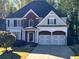Two-story home with brick accents and a two-car garage and landscaped front yard at 1658 Lightfoot Cir, Marietta, GA 30062