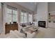 Bright living room featuring large windows, a fireplace, and neutral decor at 1658 Lightfoot Cir, Marietta, GA 30062