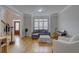 Bright living room featuring hardwood floors, modern furniture, and natural light at 1658 Lightfoot Cir, Marietta, GA 30062