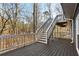 Large wood back deck with railing and stairs leading to yard at 645 Trailmore Pl, Roswell, GA 30076