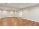 Spacious finished basement with hardwood flooring, recessed lights, and neutral walls, perfect for customization at 645 Trailmore Pl, Roswell, GA 30076