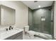Bathroom featuring gray tiled glass enclosed shower, gray vanity with marble top and modern fixtures at 645 Trailmore Pl, Roswell, GA 30076