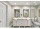 Elegant bathroom with double vanity, marble counters, and glass enclosed shower at 645 Trailmore Pl, Roswell, GA 30076