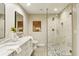 Modern bathroom features a double vanity, glass enclosed shower with unique tile, and sleek design at 645 Trailmore Pl, Roswell, GA 30076