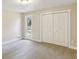 Bright bedroom featuring neutral walls, plush carpeting, a window, and a closet with bifold doors at 645 Trailmore Pl, Roswell, GA 30076