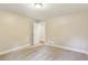Bright bedroom with neutral walls, carpeting, a window, and crisp, white trim offers a serene space at 645 Trailmore Pl, Roswell, GA 30076
