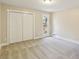 Bright bedroom featuring neutral walls, plush carpeting, a window, and a closet with bifold doors at 645 Trailmore Pl, Roswell, GA 30076