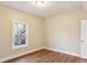 Bedroom features wood floors, a window and neutral paint at 645 Trailmore Pl, Roswell, GA 30076