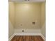 Empty walk-in closet with wood floors and utility connections at 645 Trailmore Pl, Roswell, GA 30076