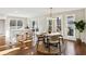 Sunlit dining area features hardwood floors, modern light fixture, and views to nature at 645 Trailmore Pl, Roswell, GA 30076
