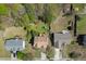 Aerial view of the neighborhood's homes with backyard play set and mature trees at 1480 Bramlett Forest Se Trl, Lawrenceville, GA 30045