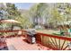 Backyard featuring a deck, grill, table and chairs, and a play structure at 1480 Bramlett Forest Se Trl, Lawrenceville, GA 30045